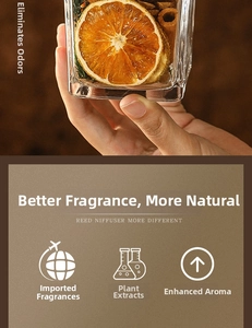 Close-up of reed diffuser glass bottle with dried orange slices and cinnamon sticks