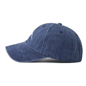 Navy blue washed cotton baseball cap featuring mountain embroidery and vintage distressed style