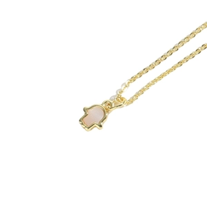 Delicate gold necklace featuring a Hamsa Hand pendant with a pink stone center