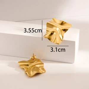 Detailed view of 18K gold plated chunky square stud earrings with wavy texture