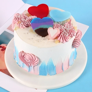 Detail view of heart shaped cake decorations on white cream frosting with pearls