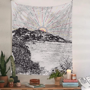Detail of bohemian mountain landscape tapestry hanging in a cozy room interior