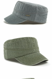 Detailed view of washed canvas fabric texture and metal logo on flat top cadet caps