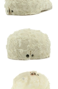 Detail view of cream lace beret showing 3D rose flowers and internal adjustable buckle