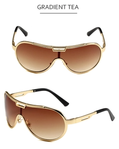 Detail of oversized pilot sunglasses with gold metal frame and gradient tea lenses