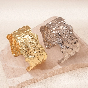 Minimalist wide metal open bangle with unique lava texture in gold and silver finish