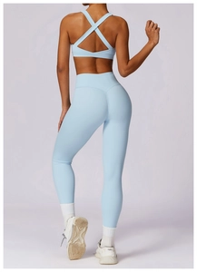 Close-up of light blue yoga set featuring cross-back sports bra and high-waist leggings