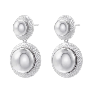 Detail showing silver double-tier spherical stud earrings with textured mesh base