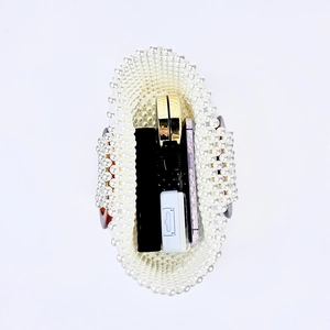 Detailed top view of handmade pearl beaded handbag showing interior storage space