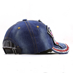 Denim baseball cap with rhinestones and silver studs in a 45-degree side view
