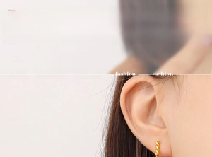 Detailed view of a gold-plated stainless steel twisted stud earring on a model ear