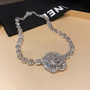 Detail view of silver sparkling camellia flower necklace with full crystal rhinestones