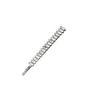 Close-up of slim silver hair clip featuring a row of rectangular inlaid rhinestones
