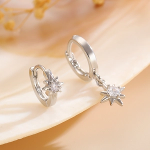 Exquisite silver-toned starburst hoop earrings with sparkling round cubic zirconia
