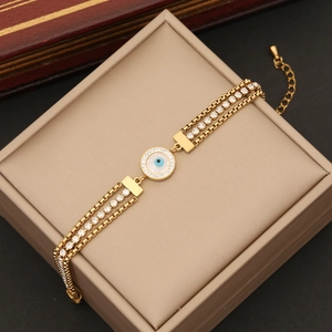 Three-layer gold stainless steel chain bracelet with evil eye and zircon charm on box
