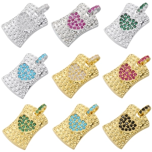 Macro view of copper heart pendants with colorful crystals in gold and silver finishes