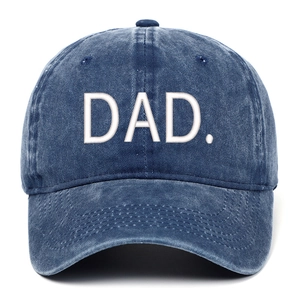 Detailed close-up of white DAD embroidery on a washed navy blue denim baseball cap