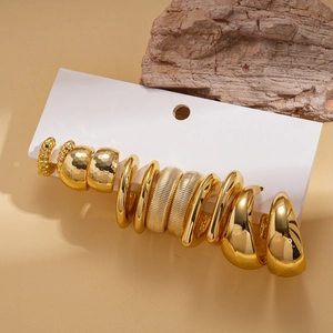 Detail of 12-piece gold hoop earring set with hammered and twisted textures on card