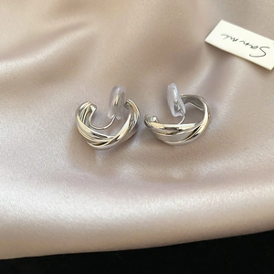Detail view of silver twisted hoop clip-on earrings with comfortable silicone pads