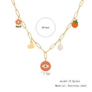 Detail of gold stainless steel necklace with colorful charms, heart, and pearl pendants