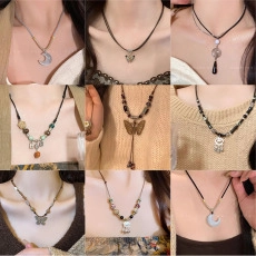 Close-up collage of elegant pendant necklaces with butterfly and heart charms on models