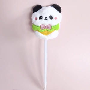 Close-up of a plush panda character ballpoint pen with a green scarf on pink background