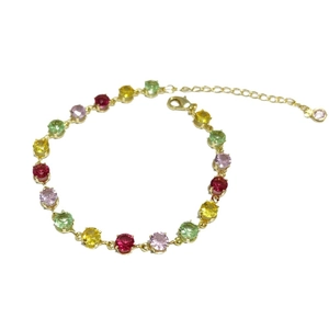 Colorful gemstone bracelet with red, yellow, green and pink stones in gold-plated settings
