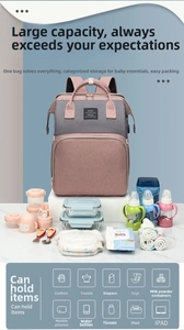 Pink and grey diaper bag showing large capacity with baby bottles and diapers nearby