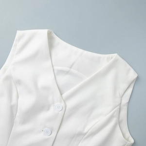 Detail of white V-neck vest with matching buttons and premium suit fabric texture
