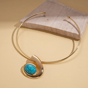 Detailed view of golden choker with oval turquoise stone and unique resin streamline design