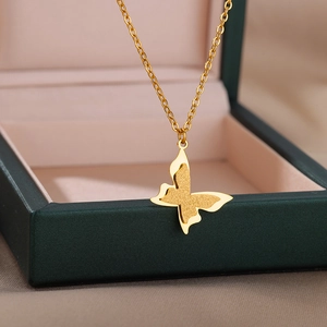 Detail of a gold 18k butterfly pendant with frosted and polished double layers