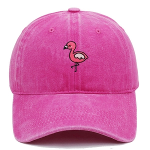 Detailed close-up of flamingo embroidery on rose pink washed cotton baseball cap