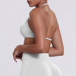 Close-up of white ribbed halter sports bra with open back and high-waist fitness shorts