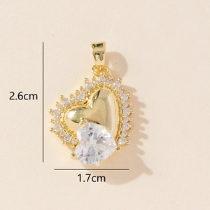 Gold heart pendant with transparent crystals and dimension specs 2.6cm by 1.7cm