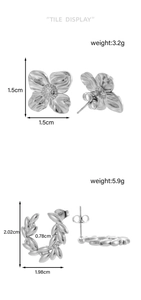 Detailed tile display of silver floral and laurel leaf stud earrings with size and weight specs