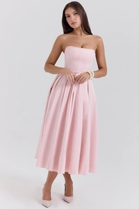 Detail of slim fit pink strapless midi dress with flared hem and corset style waist
