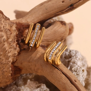 Detail of 18K gold plated J-shape earrings with triple-row design and clear stones