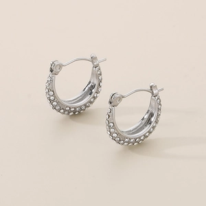Detailed close-up of U-shaped silver stainless steel earrings with sparkling micro pavé zircons