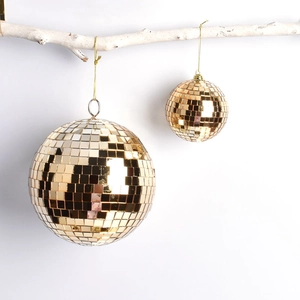 Golden mirror disco ball ornaments hanging on branches for Christmas tree decor