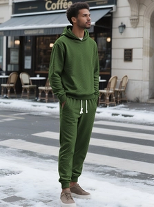 Detail shot of men's olive green track suit showing waffle knit texture and drawstring hood