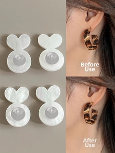 Comparison showing heart-shaped silicone earring lifters supporting heavy leopard earrings