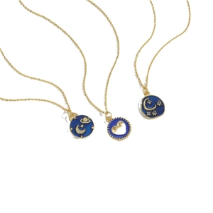 Vintage gold sun and moon star pendants with blue enamel on delicate necklaces