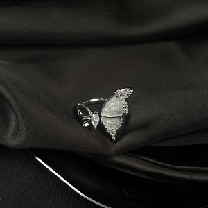 Detail of silver butterfly ring with mother of pearl inlay and marquise cut zircon stones