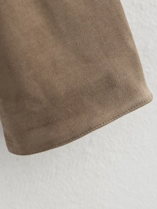 Close-up of brown faux suede fabric showing refined stitching detail on casual jacket