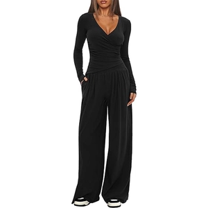Detail of black V-neck long sleeve top and matching high-waisted wide-leg pants