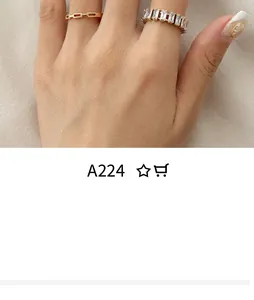 Detail of stacked gold-plated chain ring and rectangle zircon band on model's fingers
