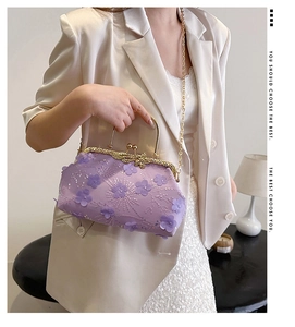 Detail of purple lace evening bag with sequins and elegant gold bow metal clasp