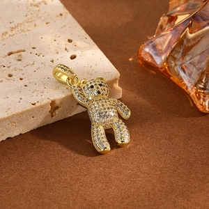 Iced-out gold panda bear pendant with sparkling crystals on a stylish aesthetic background
