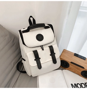 Minimalist black and white high-density backpack shown in a modern lifestyle setting