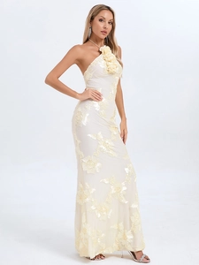 Detailed view of the 3D floral embroidery on the cream halter-neck long dress